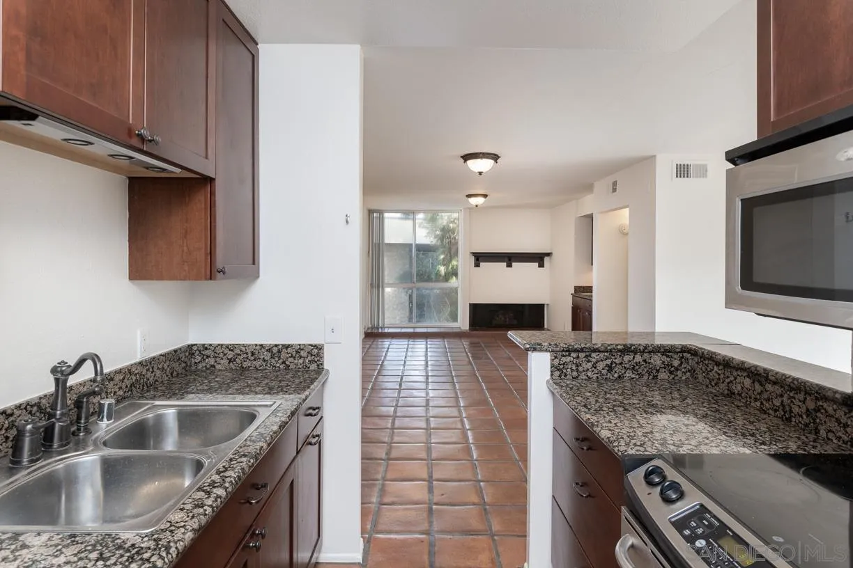 6314 Friars Road, Unit 301 San Diego, CA 92108 - Photo 8 of 31 a kitchen with a sink stove and microwave