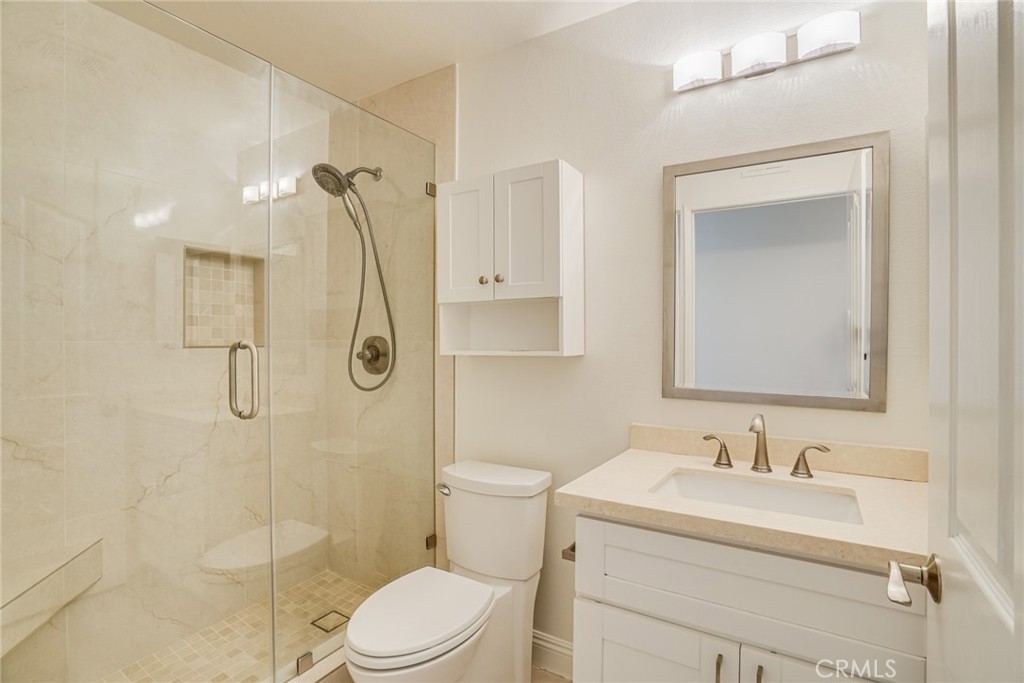 49 East Yale Loop, Unit 26 Irvine, CA 92604 - Photo 26 of 63 a bathroom with a granite countertop sink toilet and shower