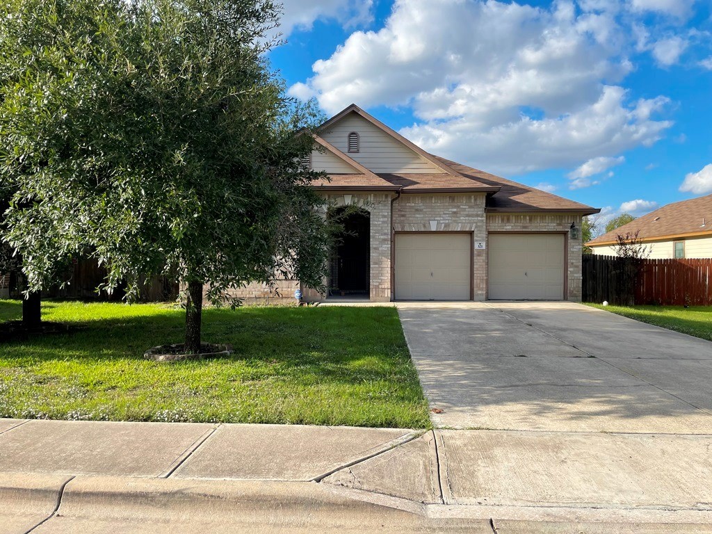 321 Apricot Drive Kyle, TX 78640 - Photo 1 of 1 a front view of a house with a yard and garage