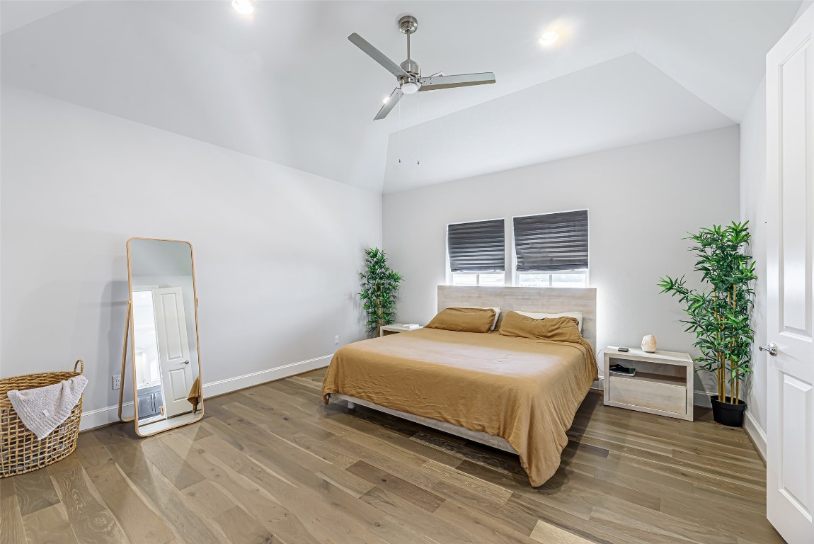 2414 Hollister Road Houston, TX 77080 - Photo 16 of 23 a bedroom with a bed and a potted plant