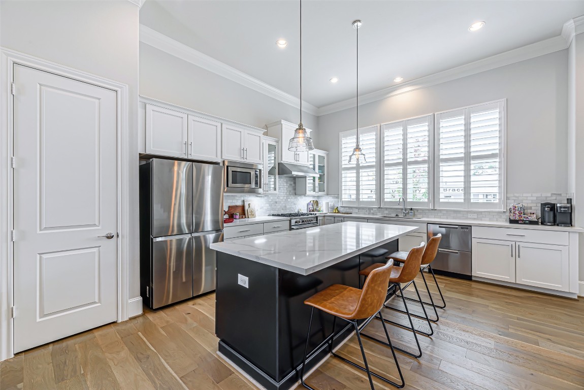 2414 Hollister Road Houston, TX 77080 - Photo 2 of 23 a kitchen with stainless steel appliances granite countertop a table chairs stove and refrigerator