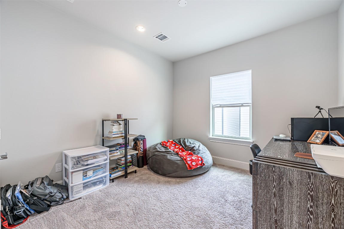 2414 Hollister Road Houston, TX 77080 - Photo 7 of 23 a room with a bed and a chair