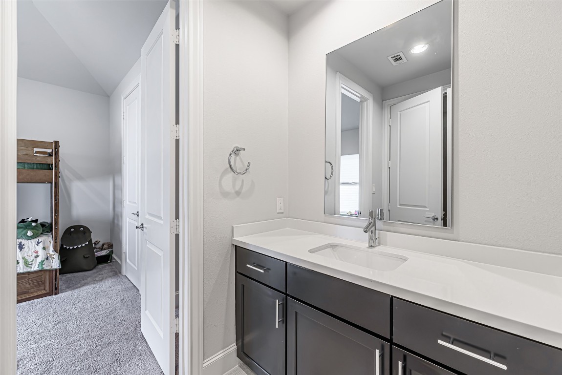 2414 Hollister Road Houston, TX 77080 - Photo 8 of 23 a en suite bathroom with a sink and a mirror