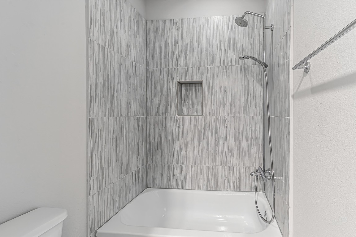 2414 Hollister Road Houston, TX 77080 - Photo 9 of 23 a bathroom with a shower and a toilet