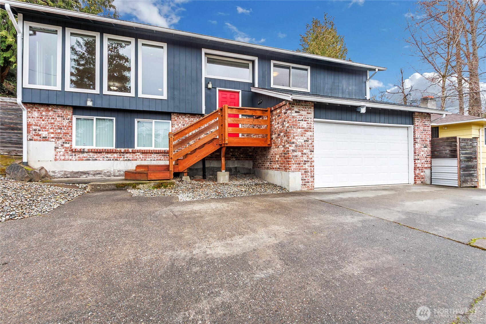 a view of a house with a garage and barbeque grill