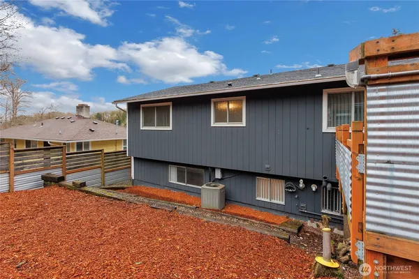 a backyard of a house with barbeque oven table and chairs