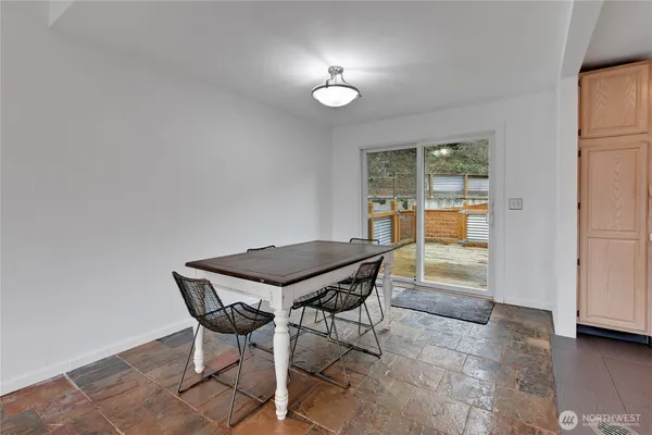 a view of a dining room with furniture and a window