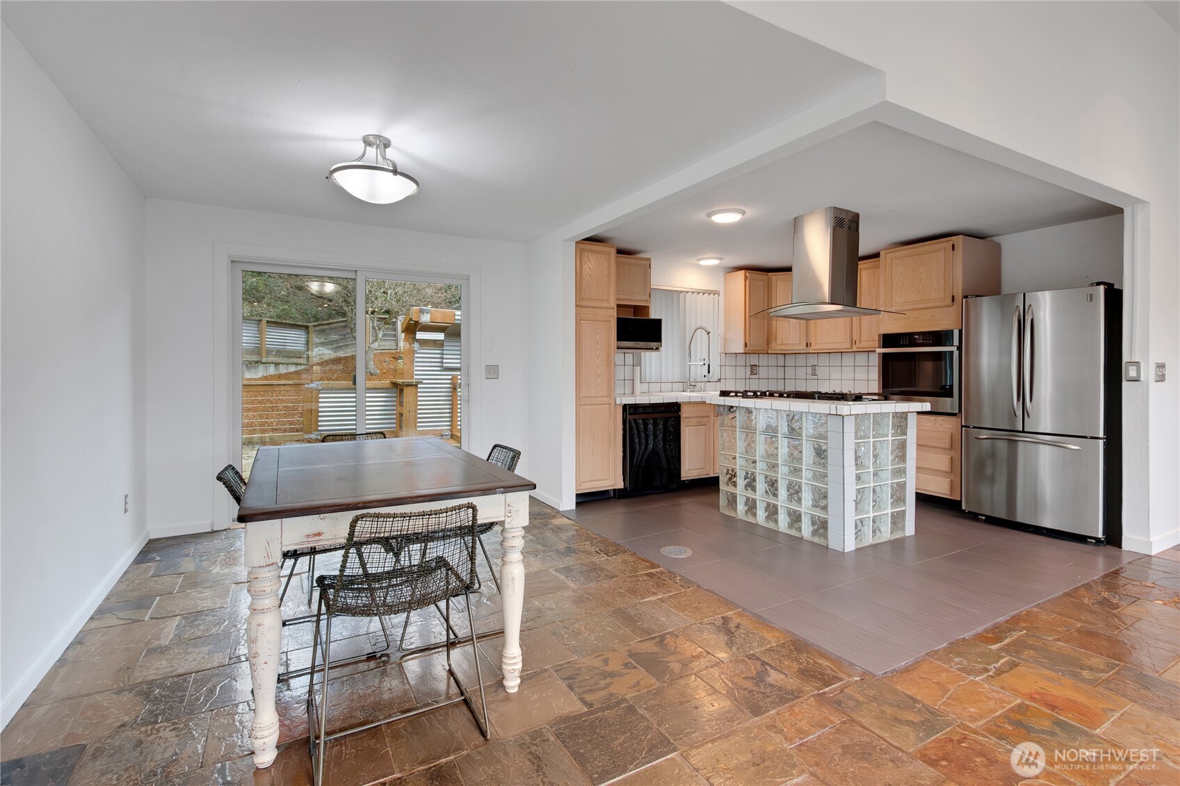 2356 South Angeline Street Seattle, WA 98108 - Photo 9 of 35 a kitchen with stainless steel appliances kitchen island granite countertop a refrigerator and cabinets