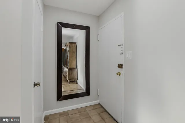 a view of a hallway with a glass door and a window