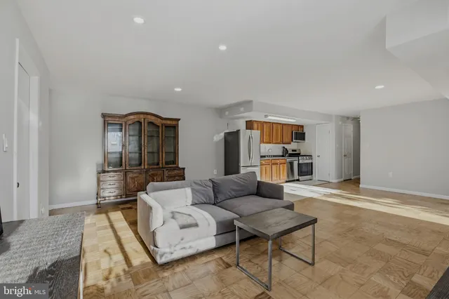 a living room with furniture and kitchen view