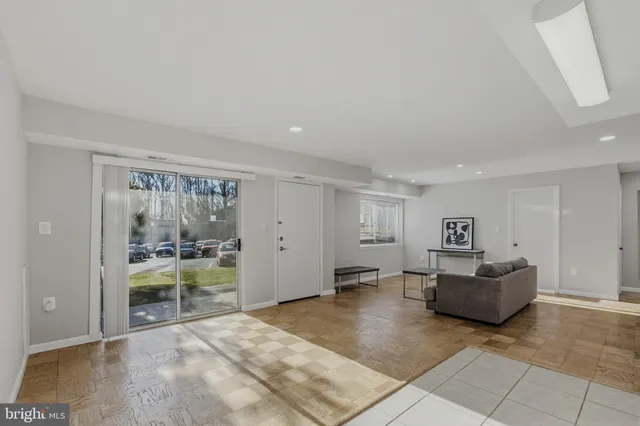 a living room with furniture and large window