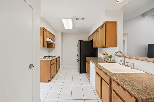 a kitchen with a sink stove and refrigerator