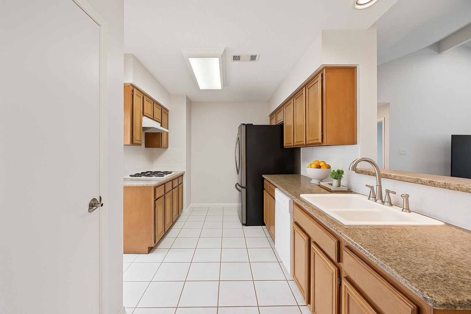 3615 Village Grove Drive Humble, TX 77396 - Photo 5 of 11 a kitchen with a sink stove and refrigerator