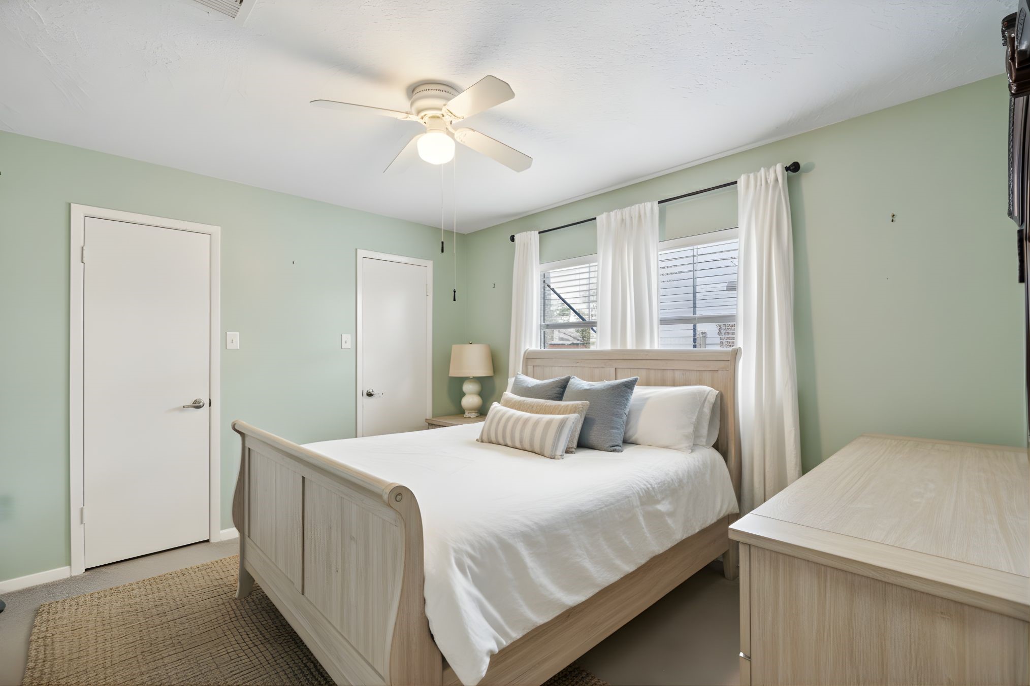 3615 Village Grove Drive Humble, TX 77396 - Photo 9 of 11 a bedroom with a large bed and a chandelier