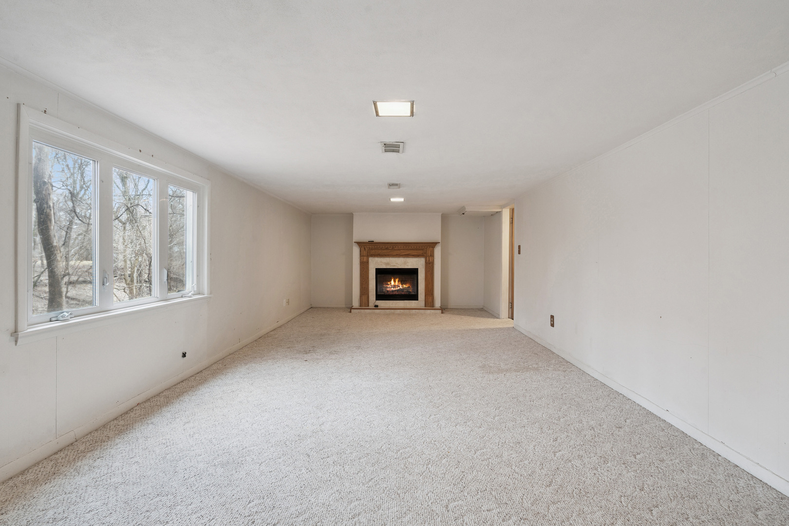 3104 15th Street A Moline, IL 61265 - Photo 12 of 31 an empty room with a window and a fireplace