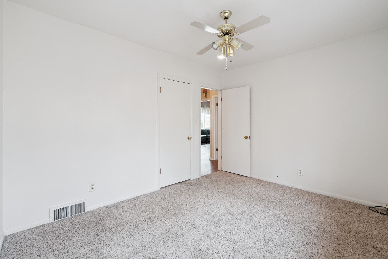 3104 15th Street A Moline, IL 61265 - Photo 21 of 31 an empty room with a chandelier fan and windows