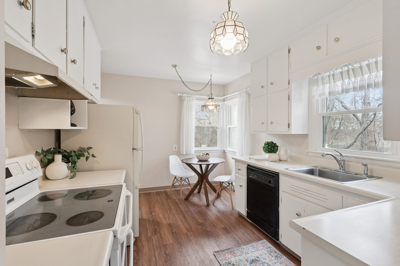 3104 15th Street A Moline, IL 61265 - Photo 7 of 31 a kitchen with a sink a stove and cabinets