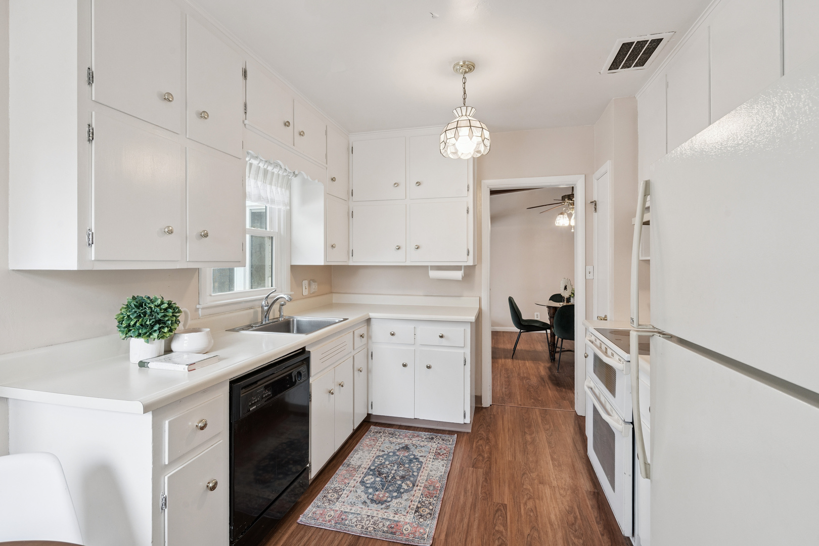 3104 15th Street A Moline, IL 61265 - Photo 8 of 31 a kitchen with a white cabinets sink and stainless steel appliances
