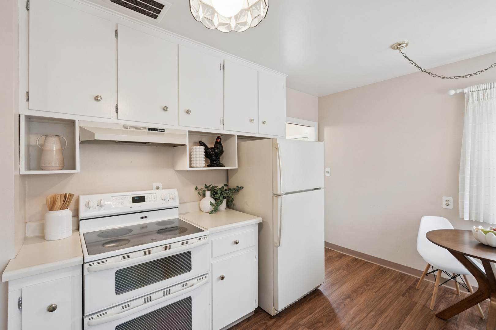 3104 15th Street A Moline, IL 61265 - Photo 9 of 31 a kitchen with a refrigerator stove and white cabinets