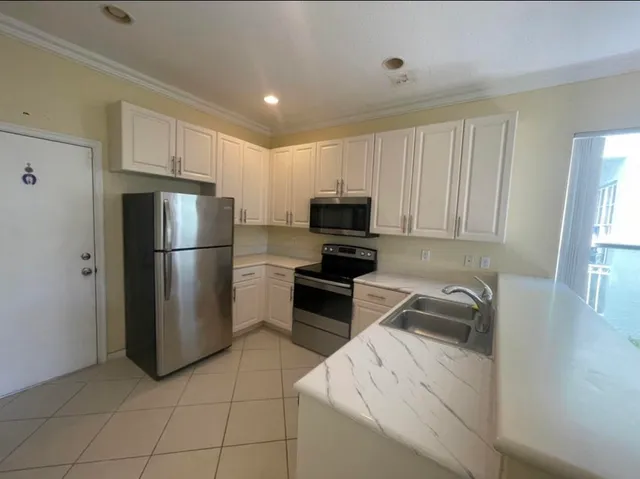 a kitchen with a refrigerator sink and microwave