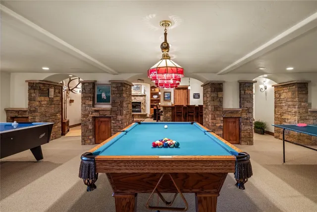 a room with pool table flat screen tv and windows