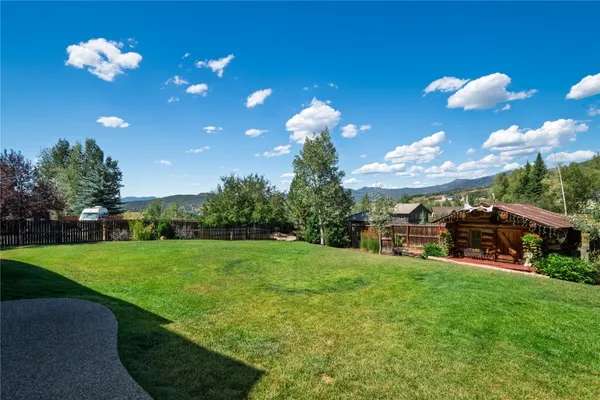 a view of a house with a yard and sitting area