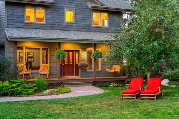 a view of a house with a backyard and a tub
