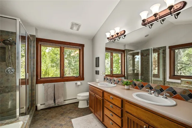 a bathroom with a bathtub and large window