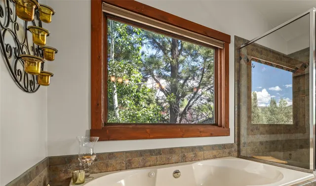 a bedroom with a bed and a potted plant
