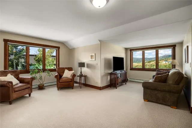 a bedroom with a bed a couch and a window