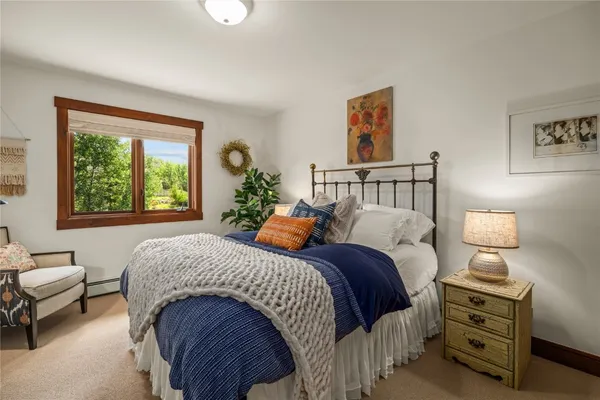 a bedroom with a large bed and a windows