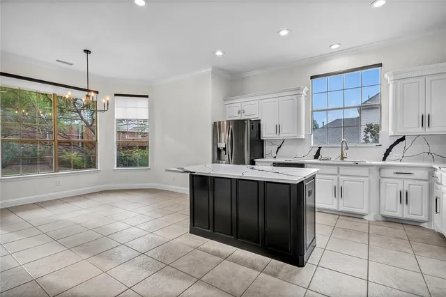a kitchen with a sink window and cabinets