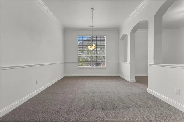 an empty room with windows and entrance