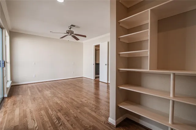 a view of a room with wooden floor and chandelier