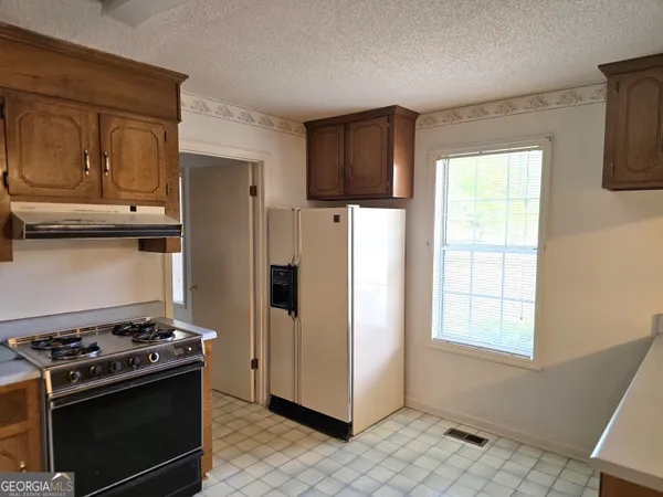 a kitchen with a stove and a refrigerator