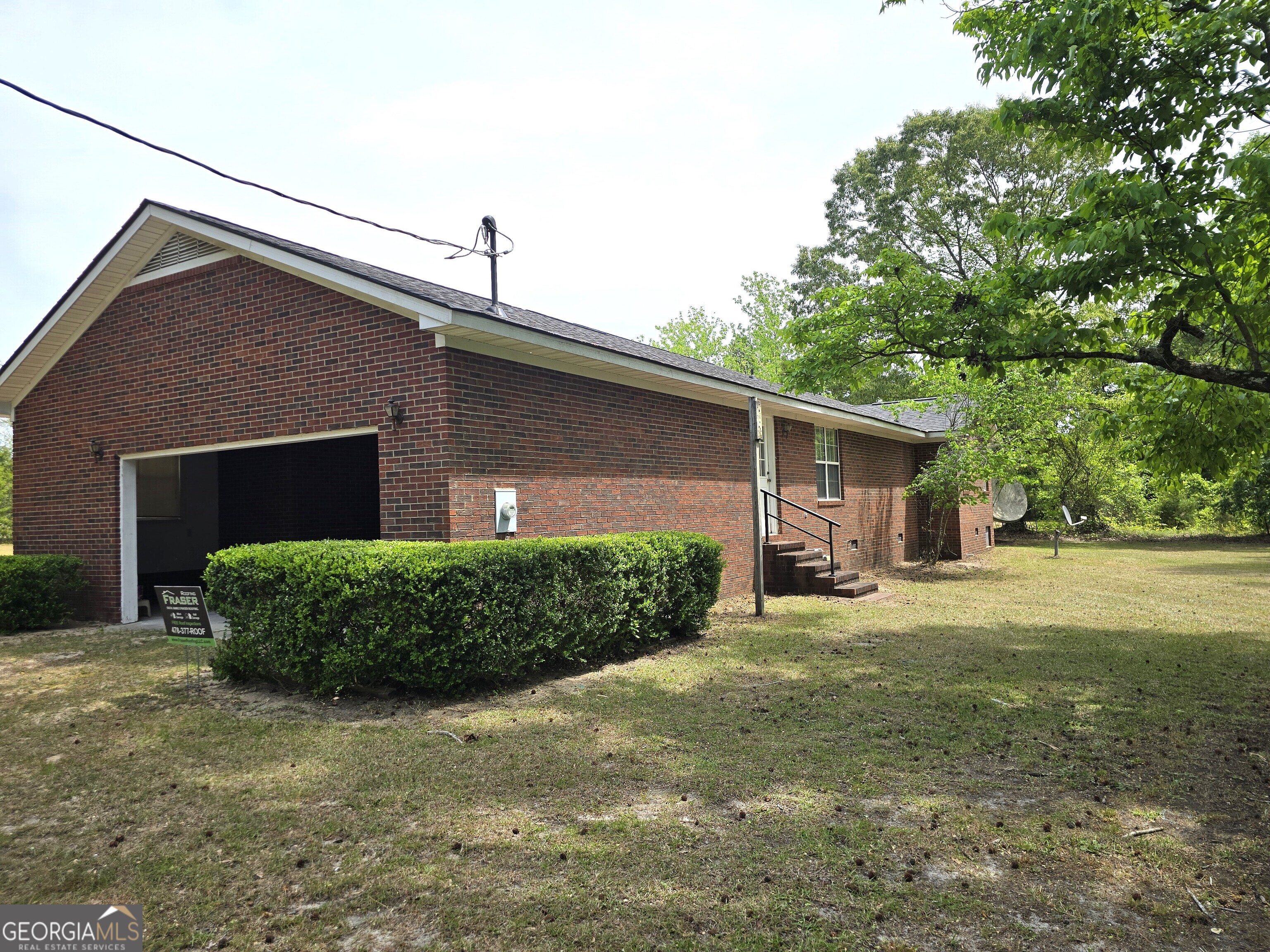 2096 Old Quaker Road Wrens, GA 30833 - Photo 2 of 23 a front view of a house with a yard and garage