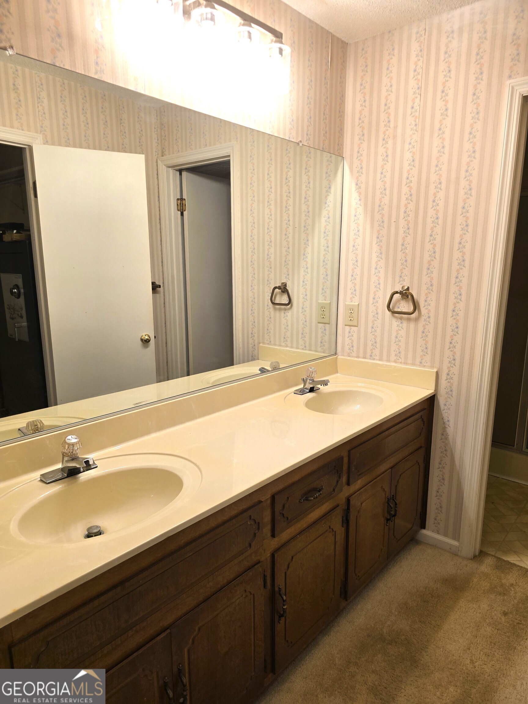 2096 Old Quaker Road Wrens, GA 30833 - Photo 23 of 23 a bathroom with a double vanity sink and a mirror