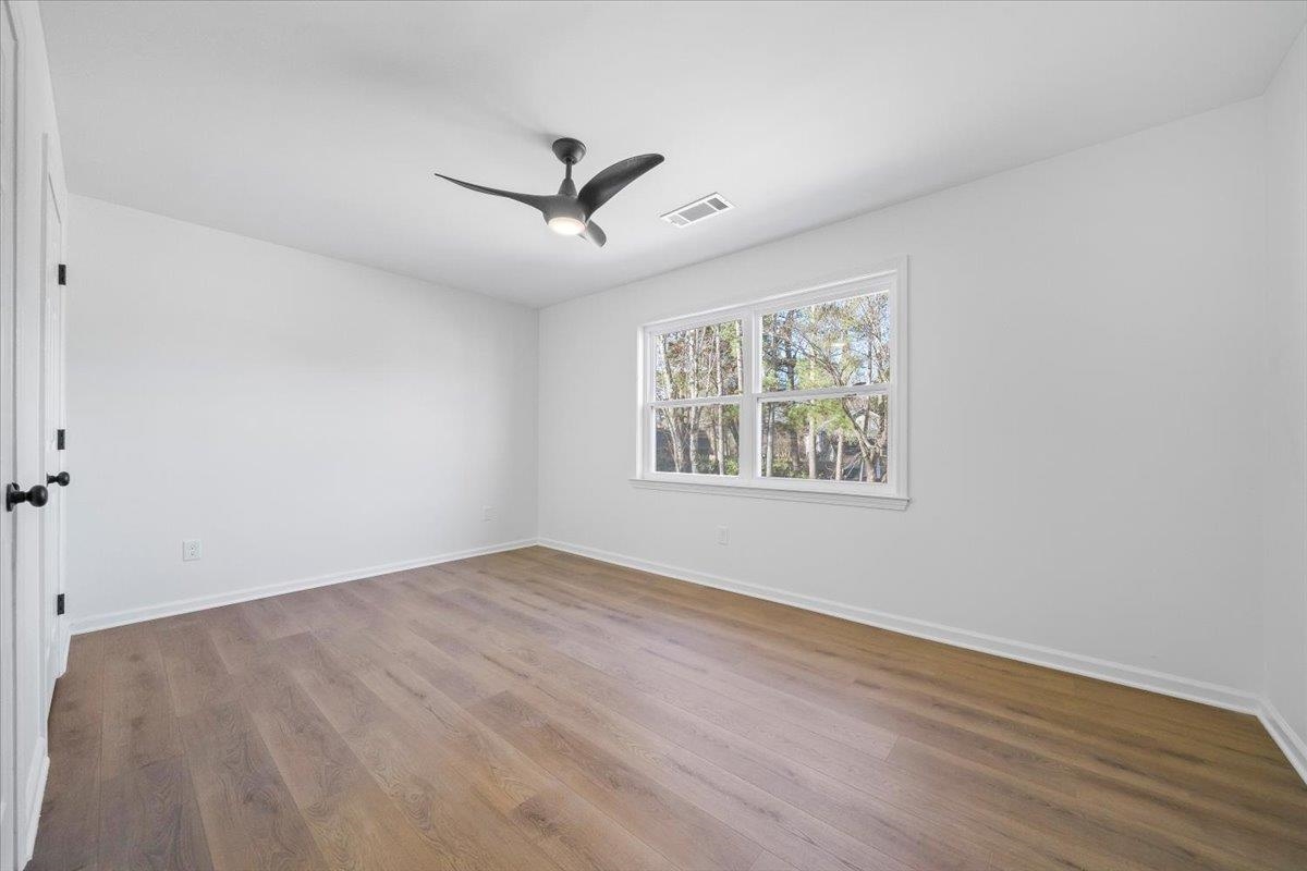 1676 Miller Farms Road Germantown, TN 38138 - Photo 20 of 37 Bright interior space featuring wood-finish flooring, white walls, and a multi-pane window