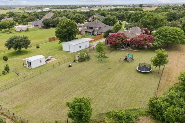 an aerial view of a house with garden space and street view