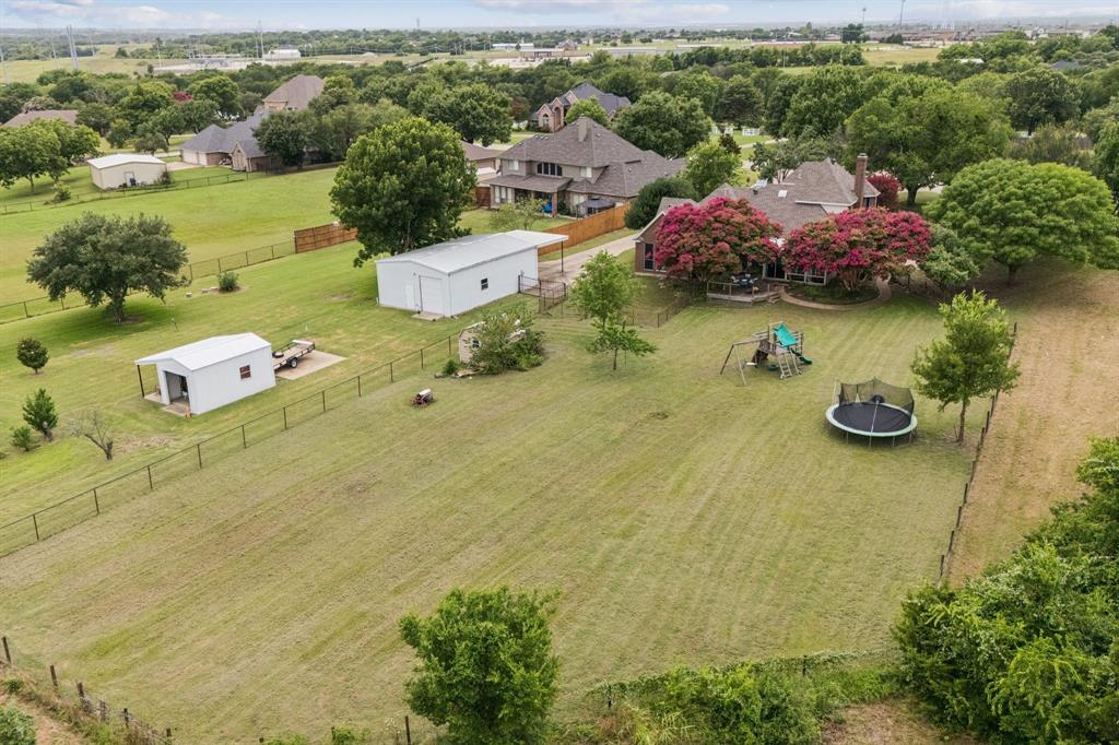 an aerial view of a house with garden space and street view