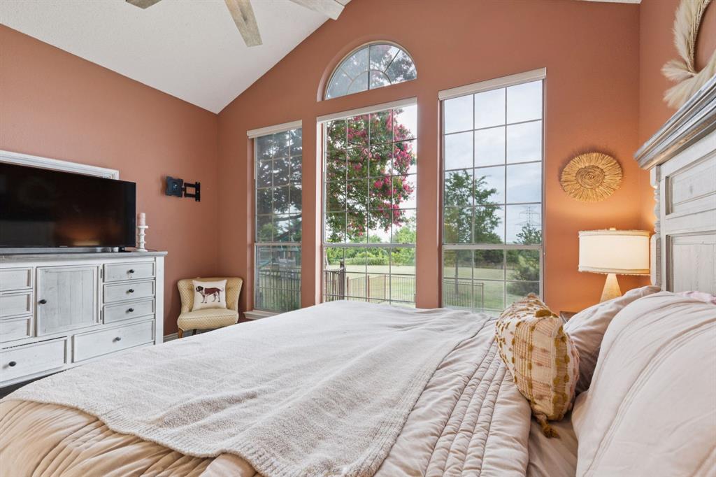 13768 Stirrup Court Forney, TX 75126 - Photo 14 of 32 a bedroom with a bed and a flat screen tv