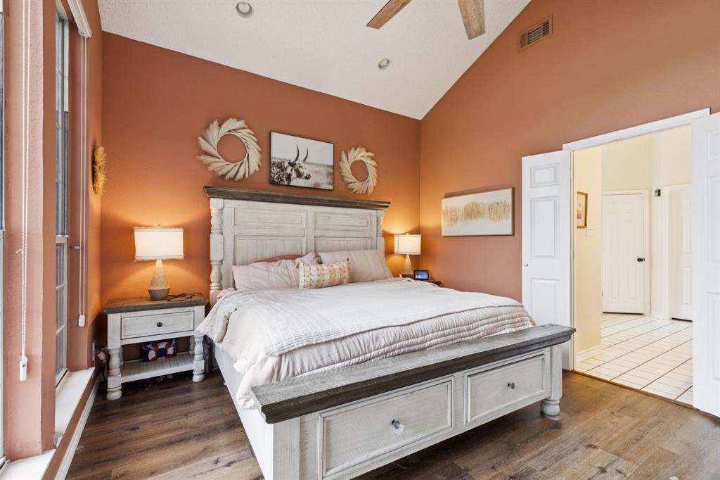 13768 Stirrup Court Forney, TX 75126 - Photo 15 of 32 a bedroom with a bed and wooden floor