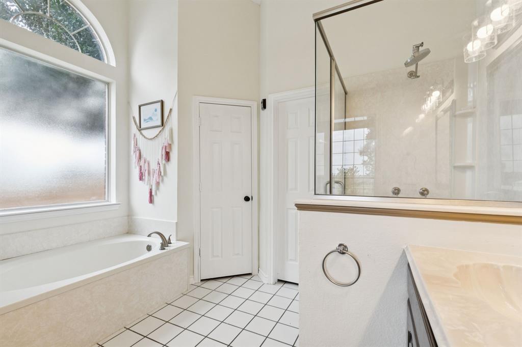 13768 Stirrup Court Forney, TX 75126 - Photo 16 of 32 a bathroom with a bathtub and a sink