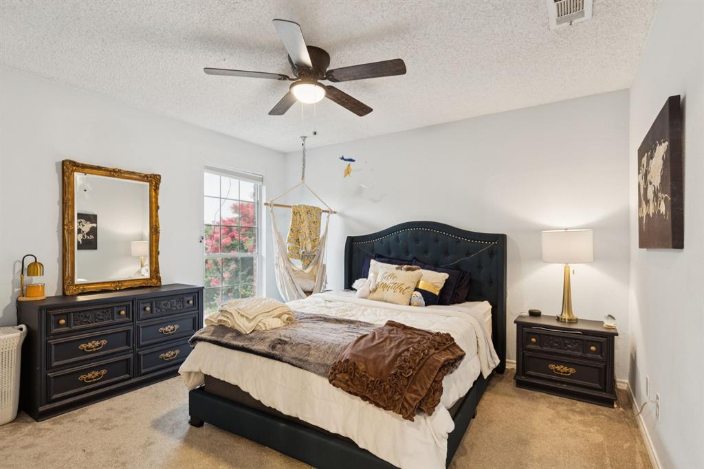 13768 Stirrup Court Forney, TX 75126 - Photo 19 of 32 a bedroom with a bed and a dresser