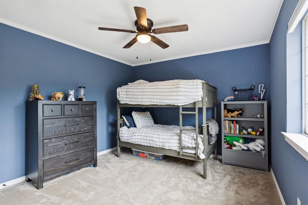 13768 Stirrup Court Forney, TX 75126 - Photo 21 of 32 a bedroom with a bed and furniture