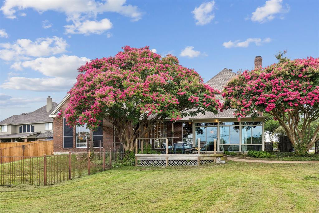 13768 Stirrup Court Forney, TX 75126 - Photo 26 of 32 a front view of a house with a garden and swimming pool