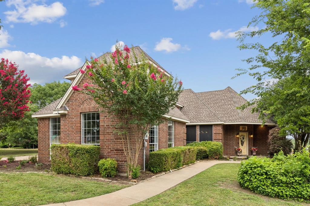 13768 Stirrup Court Forney, TX 75126 - Photo 32 of 32 a front view of a house with a yard and potted plants