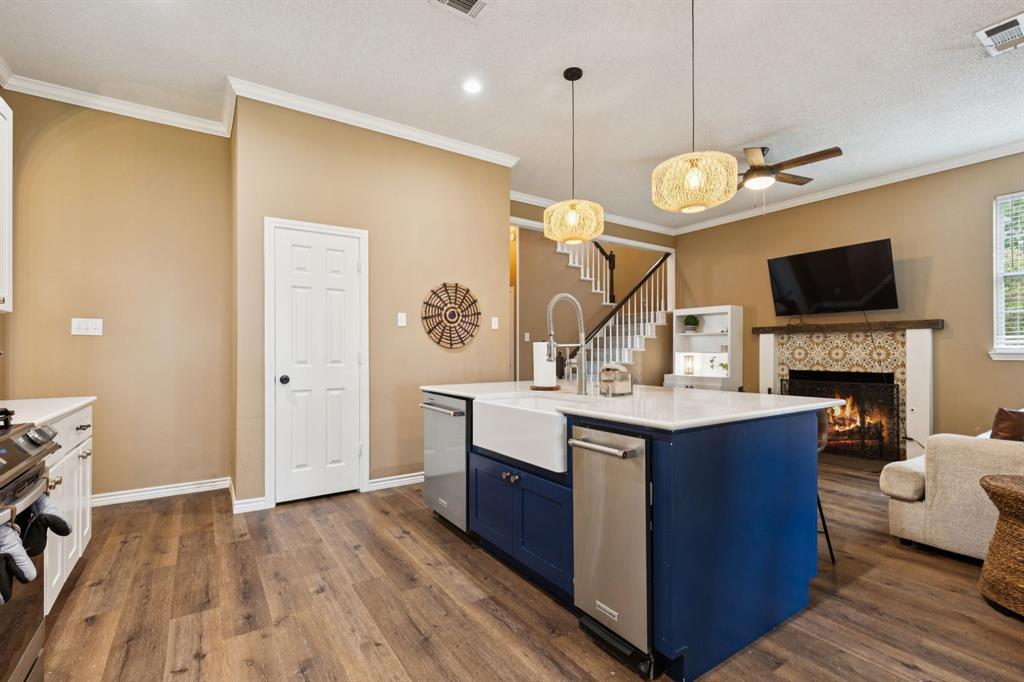 13768 Stirrup Court Forney, TX 75126 - Photo 5 of 32 a large kitchen with stainless steel appliances a stove oven and a wooden floor