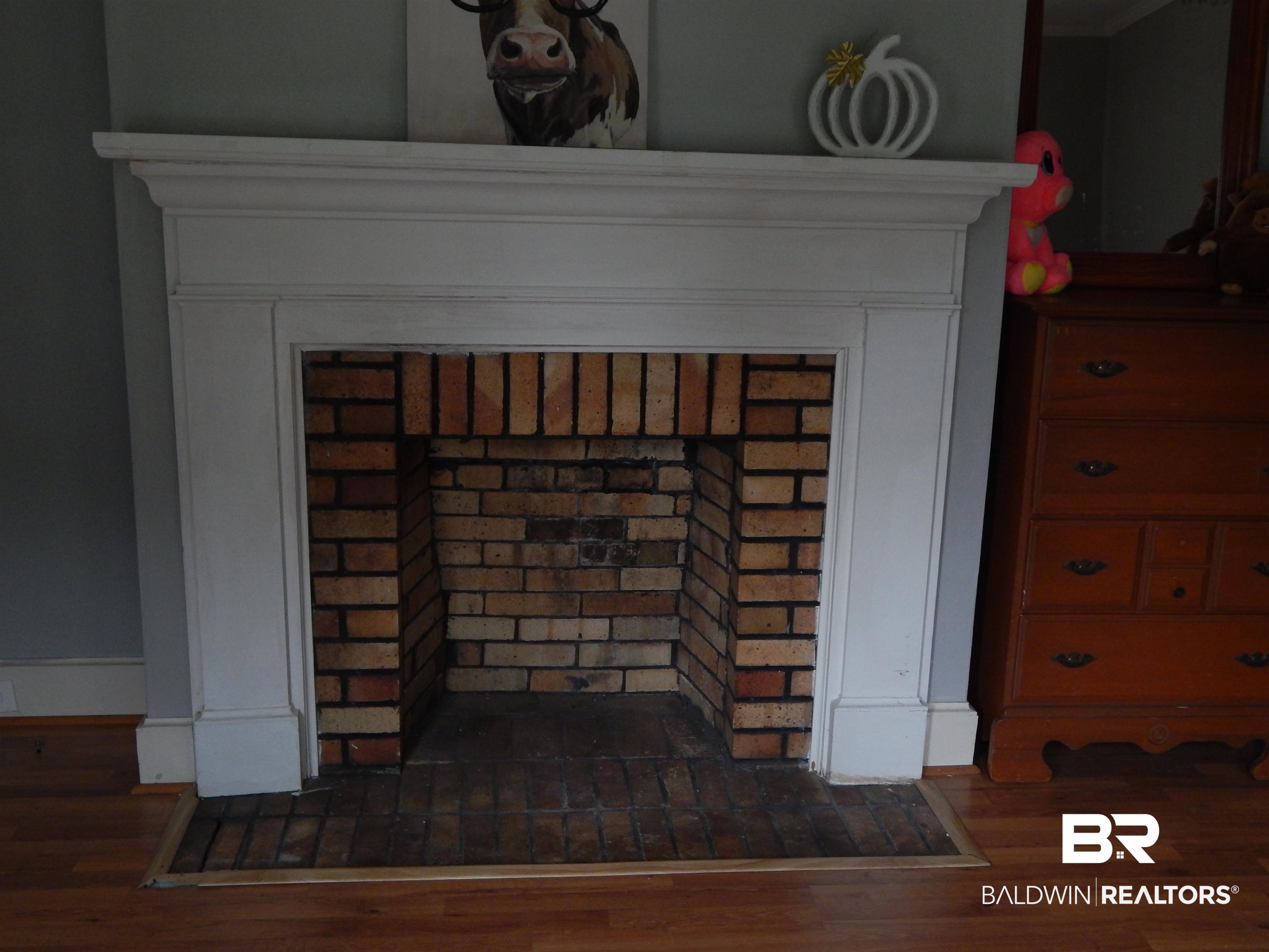 309 Bellview Avenue Evergreen, AL 36401 - Photo 8 of 27 Detailed view of a fireplace and wood finished floors