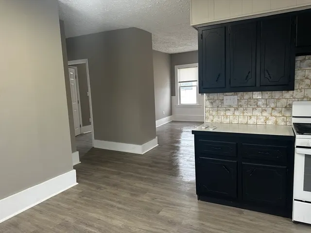 a kitchen with granite countertop wooden cabinets and granite counter tops